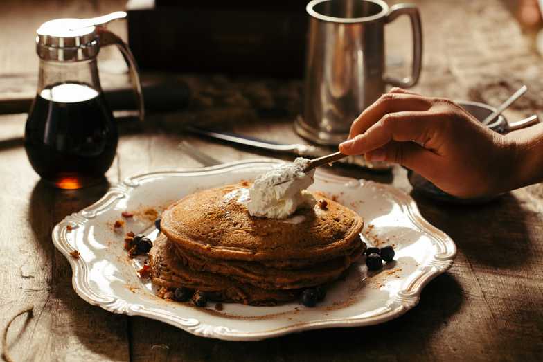 Three pancake stack of blueberry pancakes with syrup